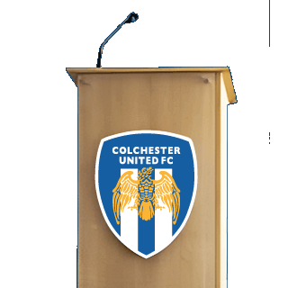 Image of a lectern with a Colchester United badge on the front of it